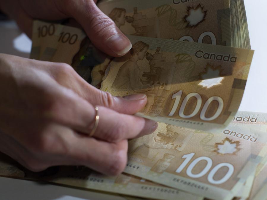 Canadian $100 bills are counted in Toronto, Feb. 2, 2016. Graeme Roy/The Canadian Press