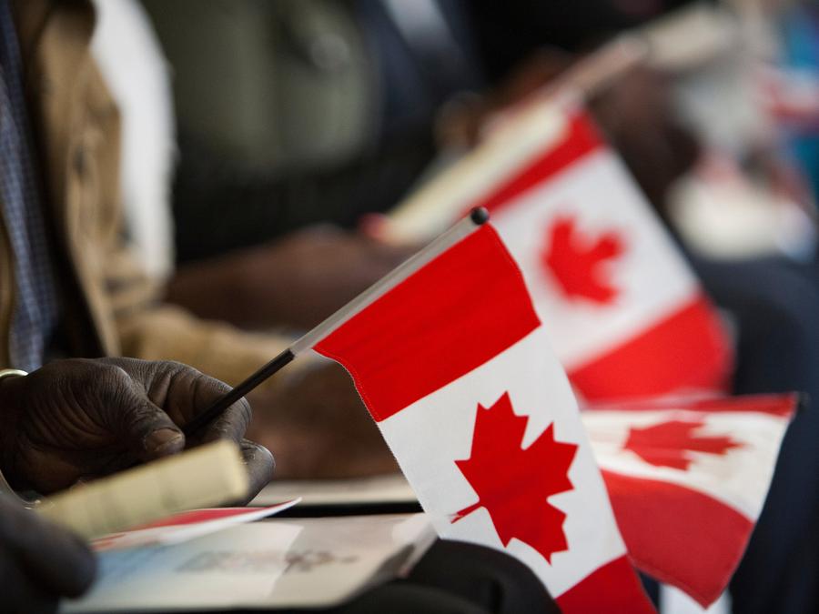 30 new Canadian citizens and their flags during a citizenship ceremony at the ISS of BC Welcome Centre in Vancouver, March 29, 2017. Rafal Gerszak/The Globe and Mail